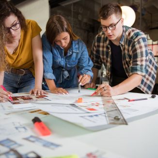 Female,Designers,Discussing,Over,Blueprint,With,Male,Designer.,One,Of Female,Designers,Discussing,Over,Blueprint,With,Male,Designer.,One,Of